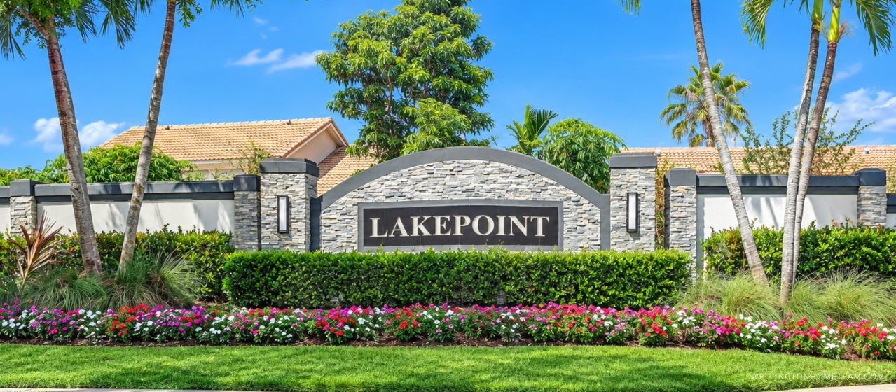 Lake Point community entrance sign surrounded by palm trees in Wellington, FL