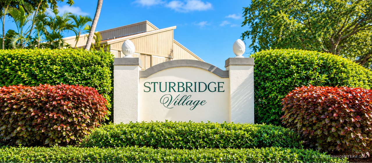 Sturbridge Village community entrance sign surrounded by palm trees in Wellington, FL