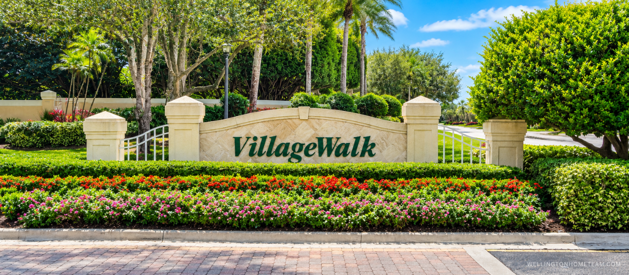 VillageWalk community entrance sign surrounded by palm trees in Wellington, FL