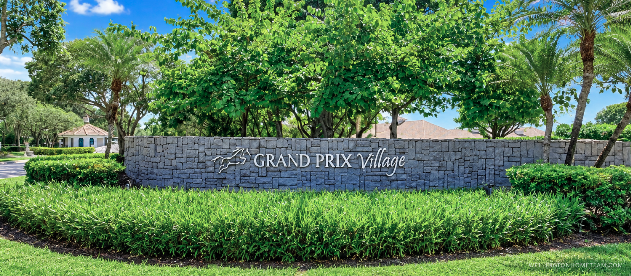 Grand Prix Village community entrance sign surrounded by palm trees in Wellington, FL