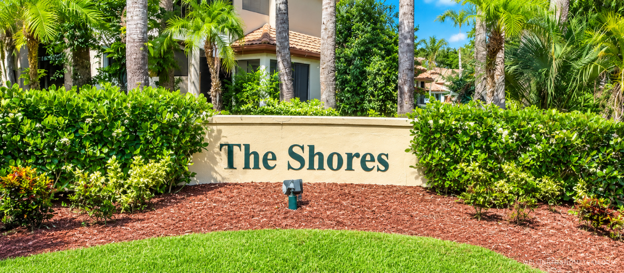 The Shores community entrance sign surrounded by palm trees in Wellington, FL