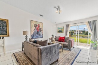 Grand Isles Wellington FL Real Estate and Community Guide Lakefront Living Room with Sliding Doors